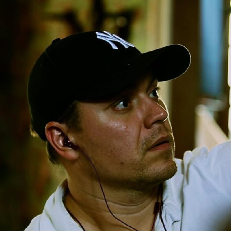 Theodore Melfi on set, wearing a cap and earpiece